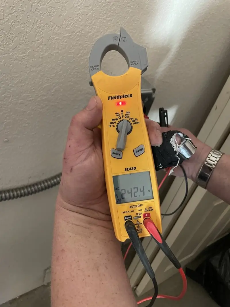 Voltage testing with clamp meter during Outlet Installation in Logan